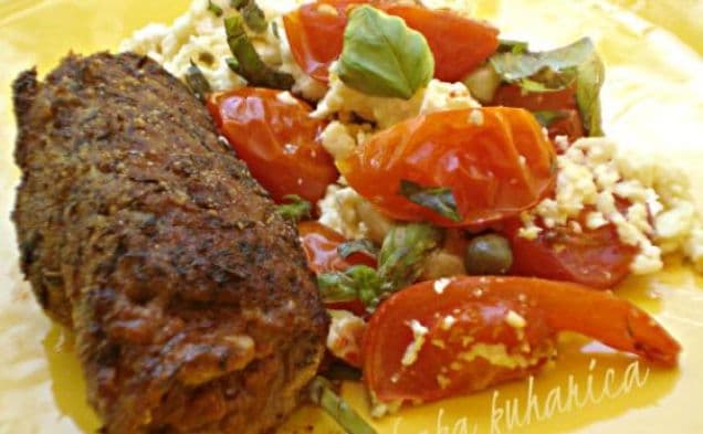 Steaks with pesto, tomatoes and feta cheese